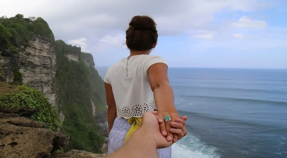 guy starts calling instead of texting - cliff, beach, holding hands